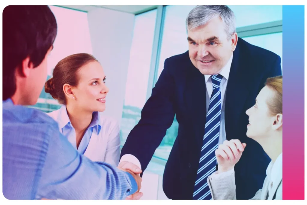 Two men shaking hands to illustrate article on different recruitment models. By Sebastian Herrmann on Unsplash